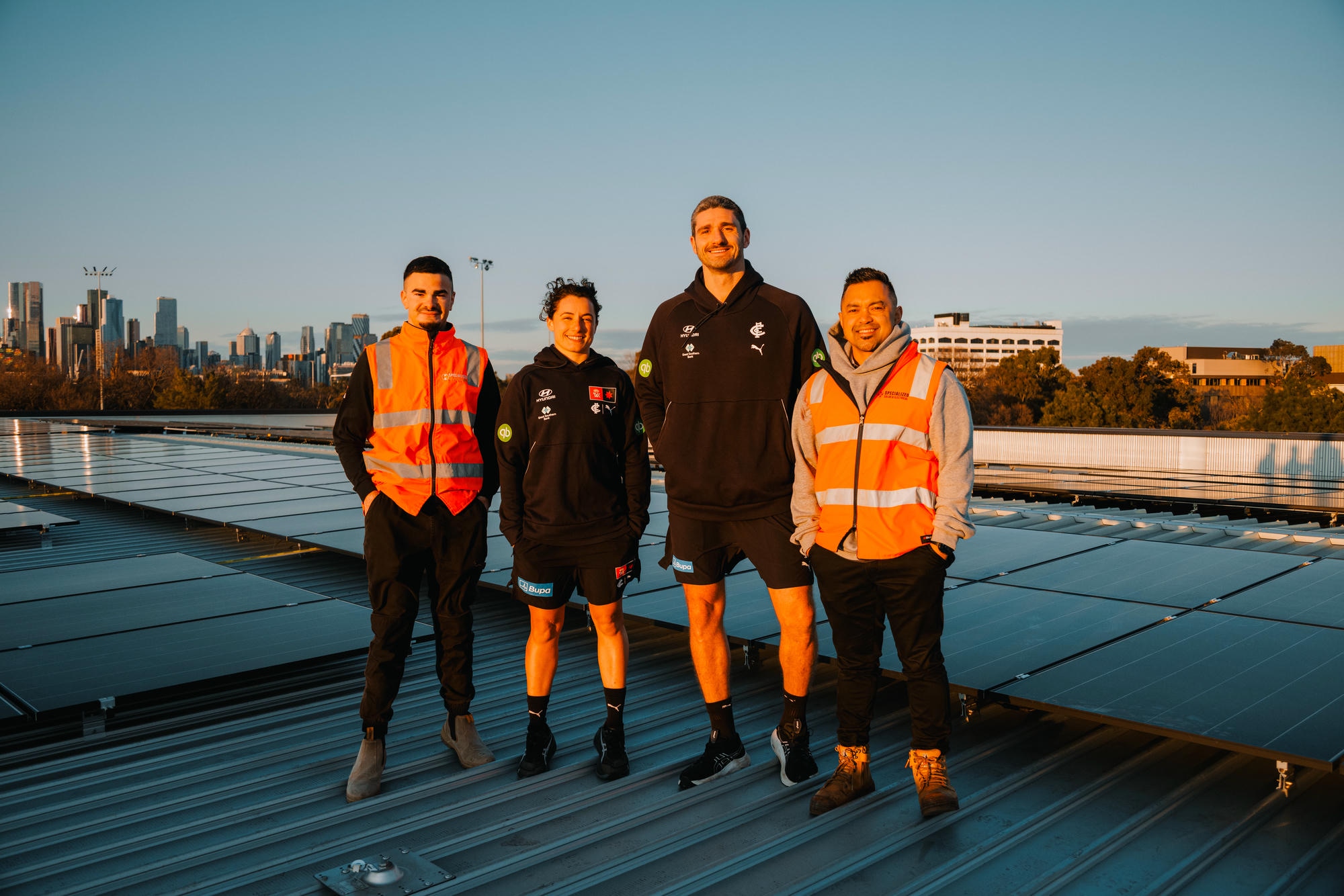 Carlton FC players with the Specialized Solar & Electrical crew